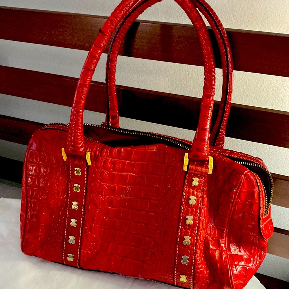 TOUS leather. Hardware is not damage and is in golden color.